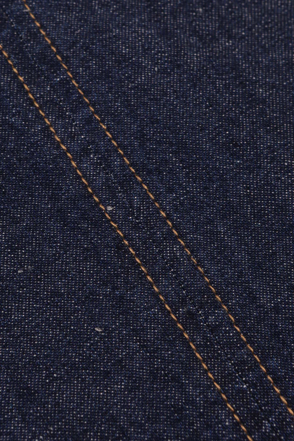 Close-up of blue denim fabric with a diagonal stitch