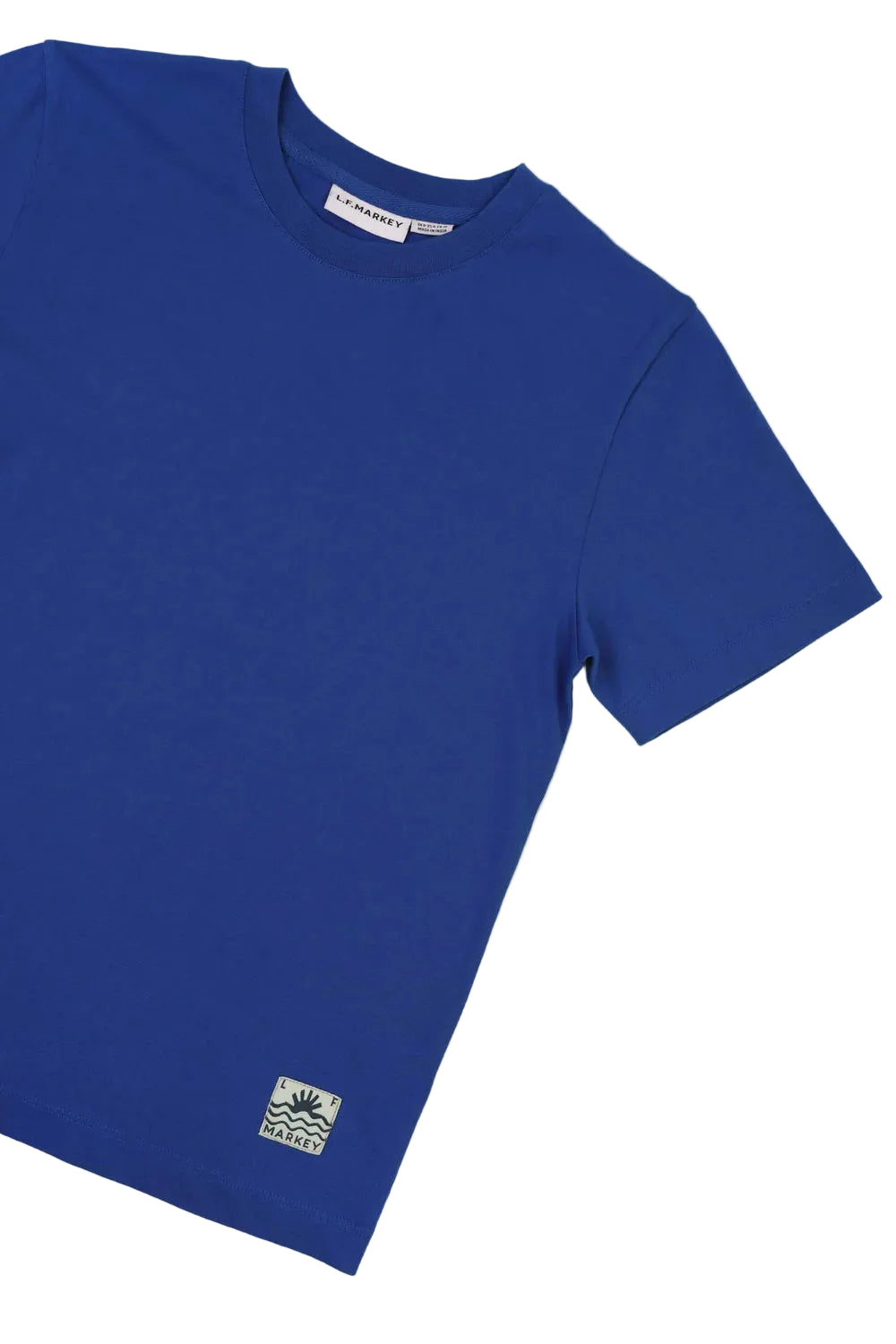 Blue t-shirt with a logo on a light green background