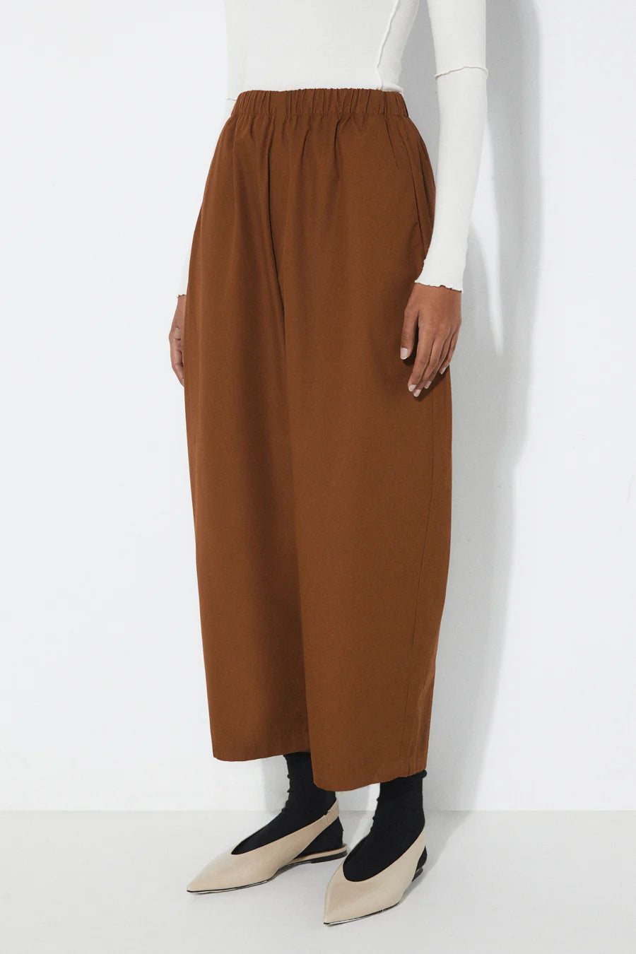 Rita Row brown wide-leg pants worn by a person on a white background