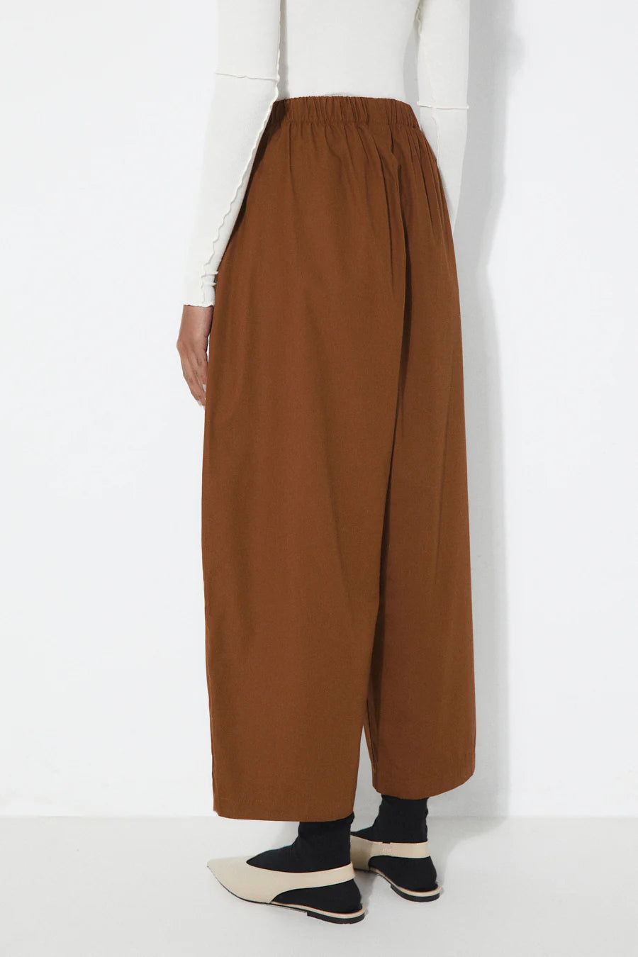 Rita Row tobacco wide-leg pants worn by a person on a white background