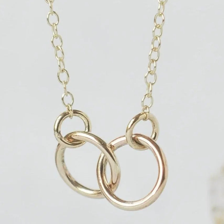 necklace on white background, connected by two gold hoopes