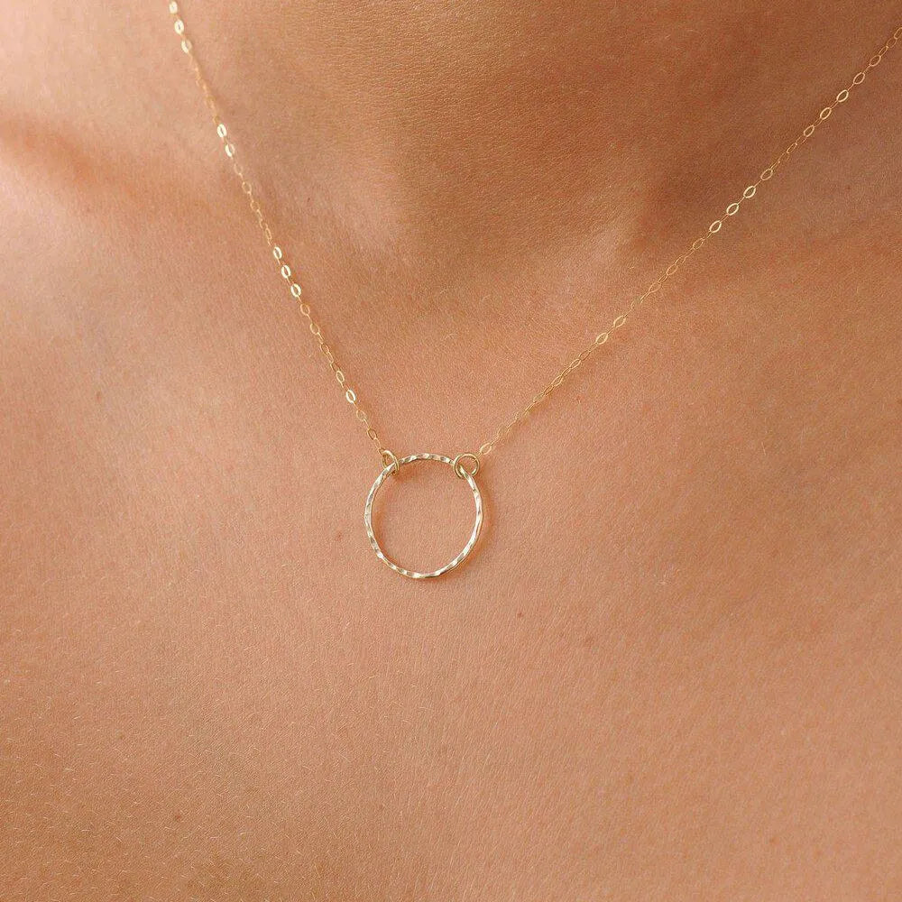 gold necklace on a woman's neck 