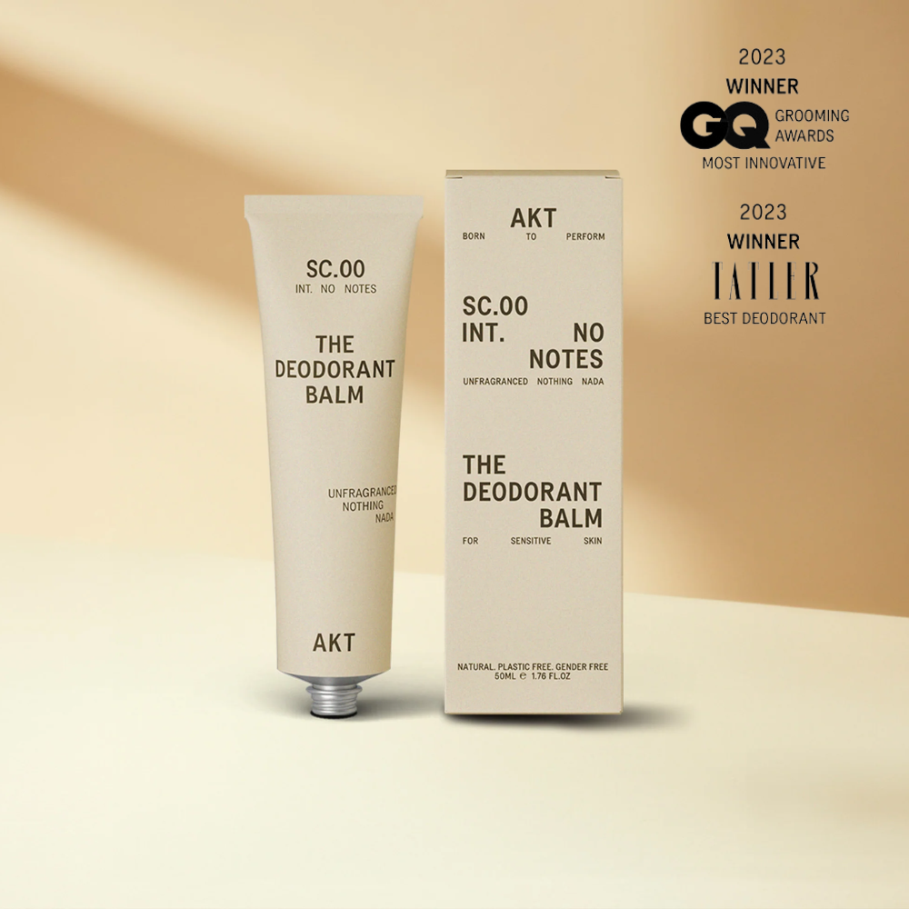 Deodorant balm tube and packaging with awards on a beige background