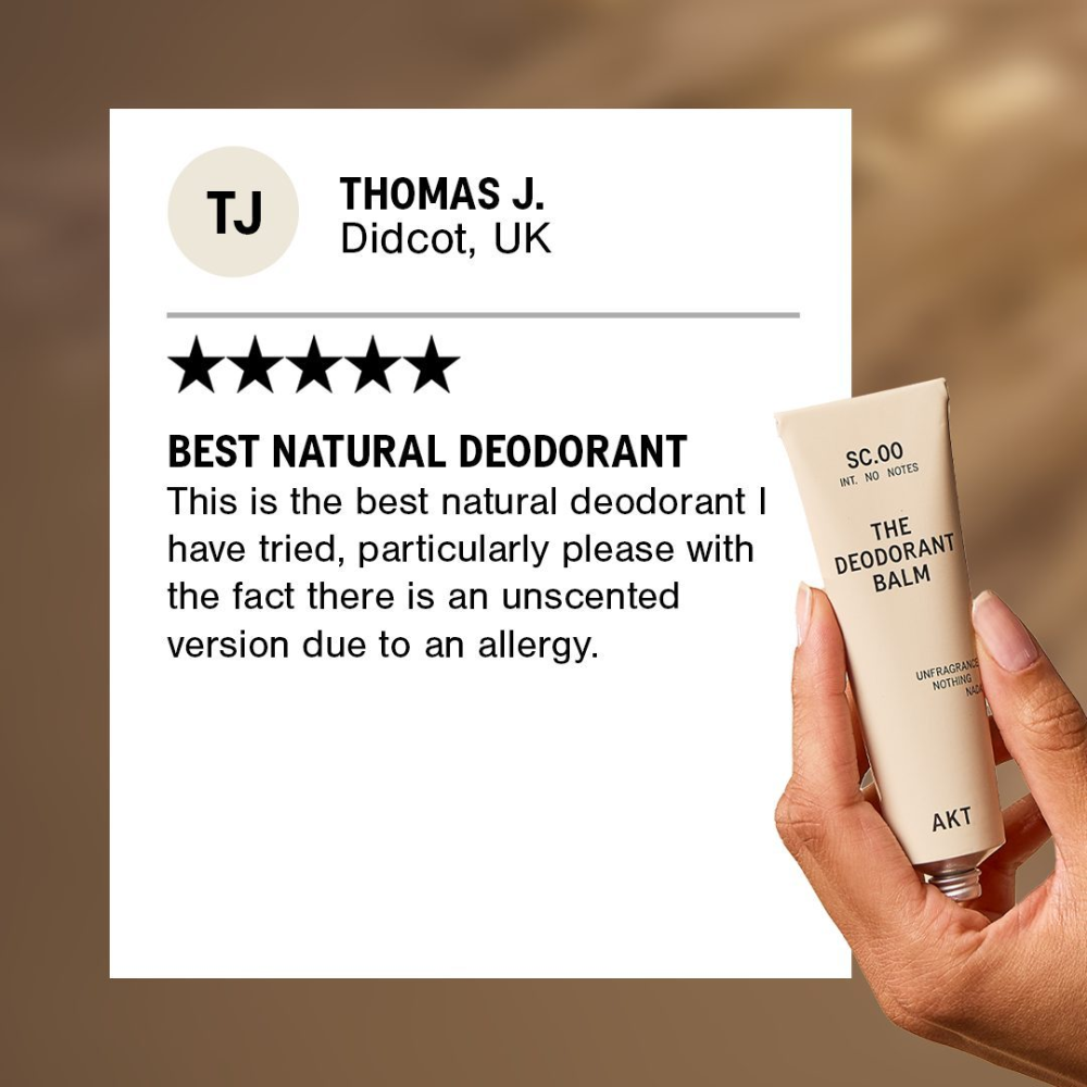 Hand holding a natural deodorant balm with a five-star review on a brown background