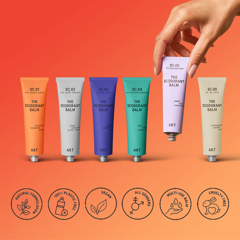 Set of colorful deodorant balm tubes with a hand holding one, on an orange background with brand icons below.