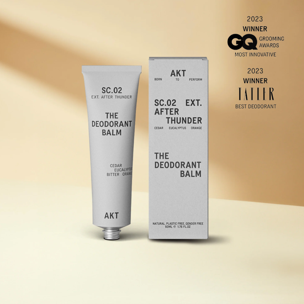 Deodorant balm tube and packaging with awards on a beige background