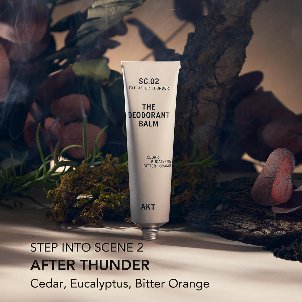 Deodorant balm tube labeled 'SC.02 THE DEODORANT BALM' with natural elements in the background