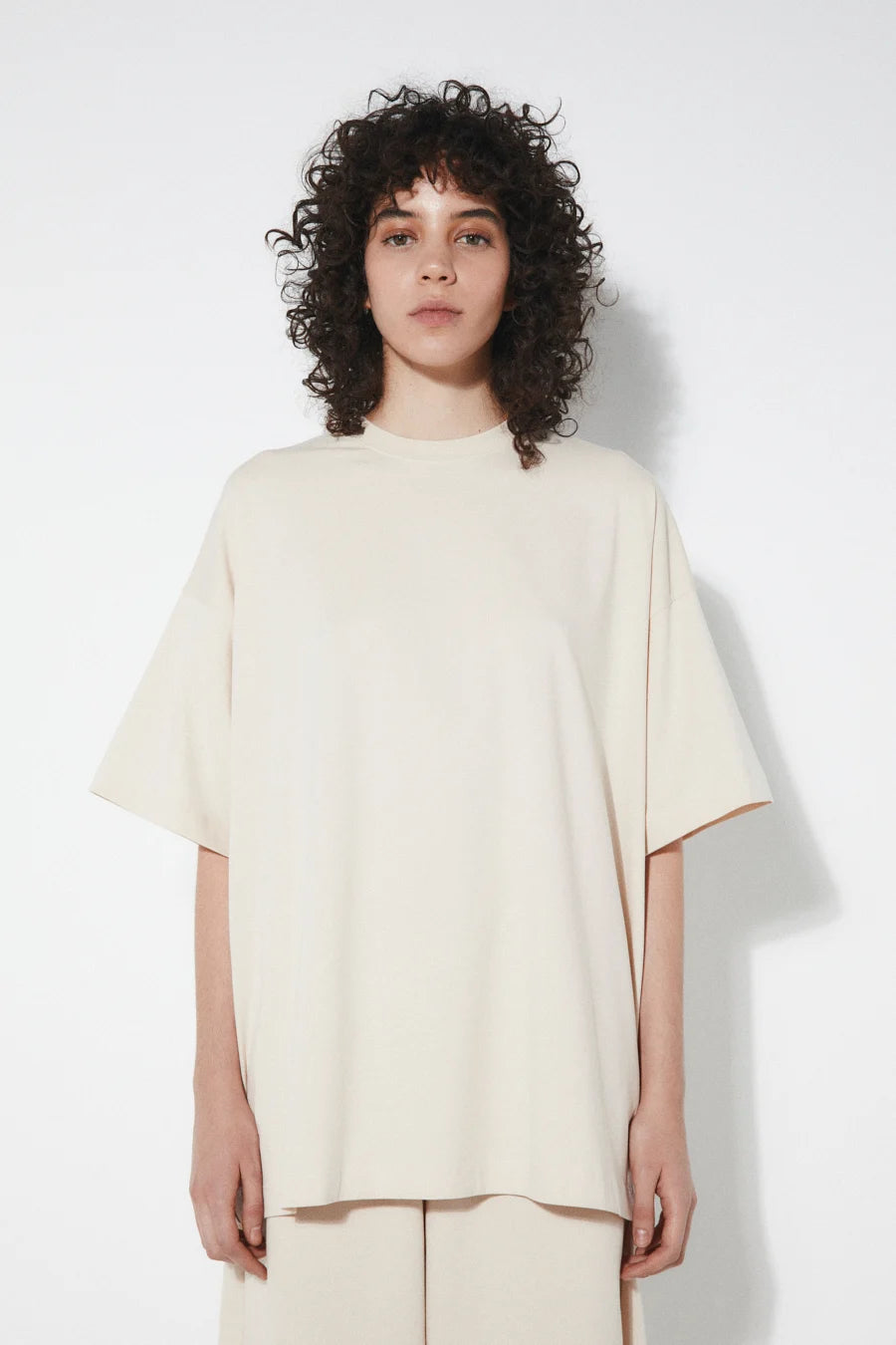 Person wearing a Rita Row beige oversized t-shirt against a white background