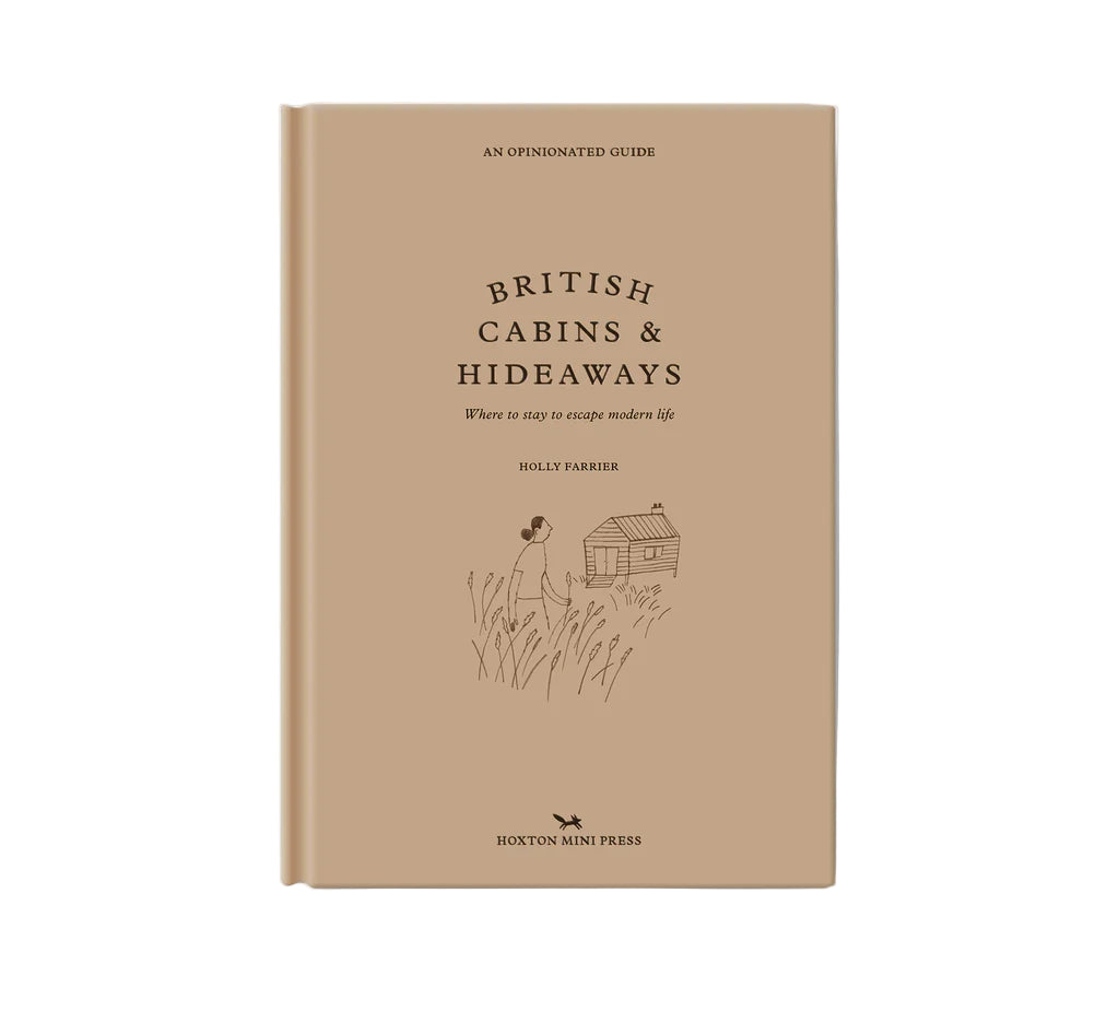 Book titled 'British Cabins & Hideaways' on a beige background