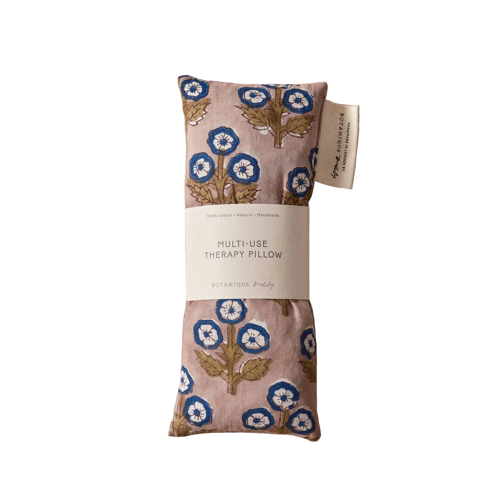 Floral-patterned multi-use therapy pillow on a beige fabric background