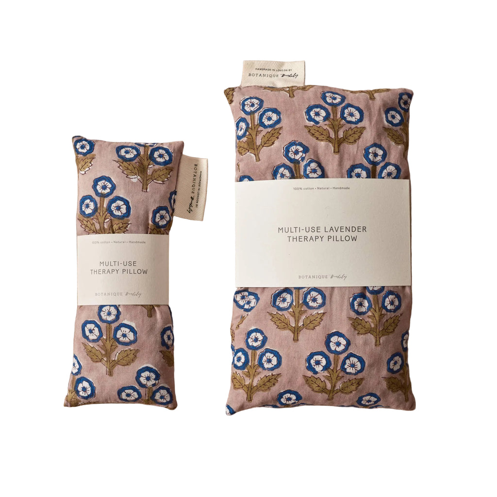 Two floral-patterned therapy pillows on a beige background