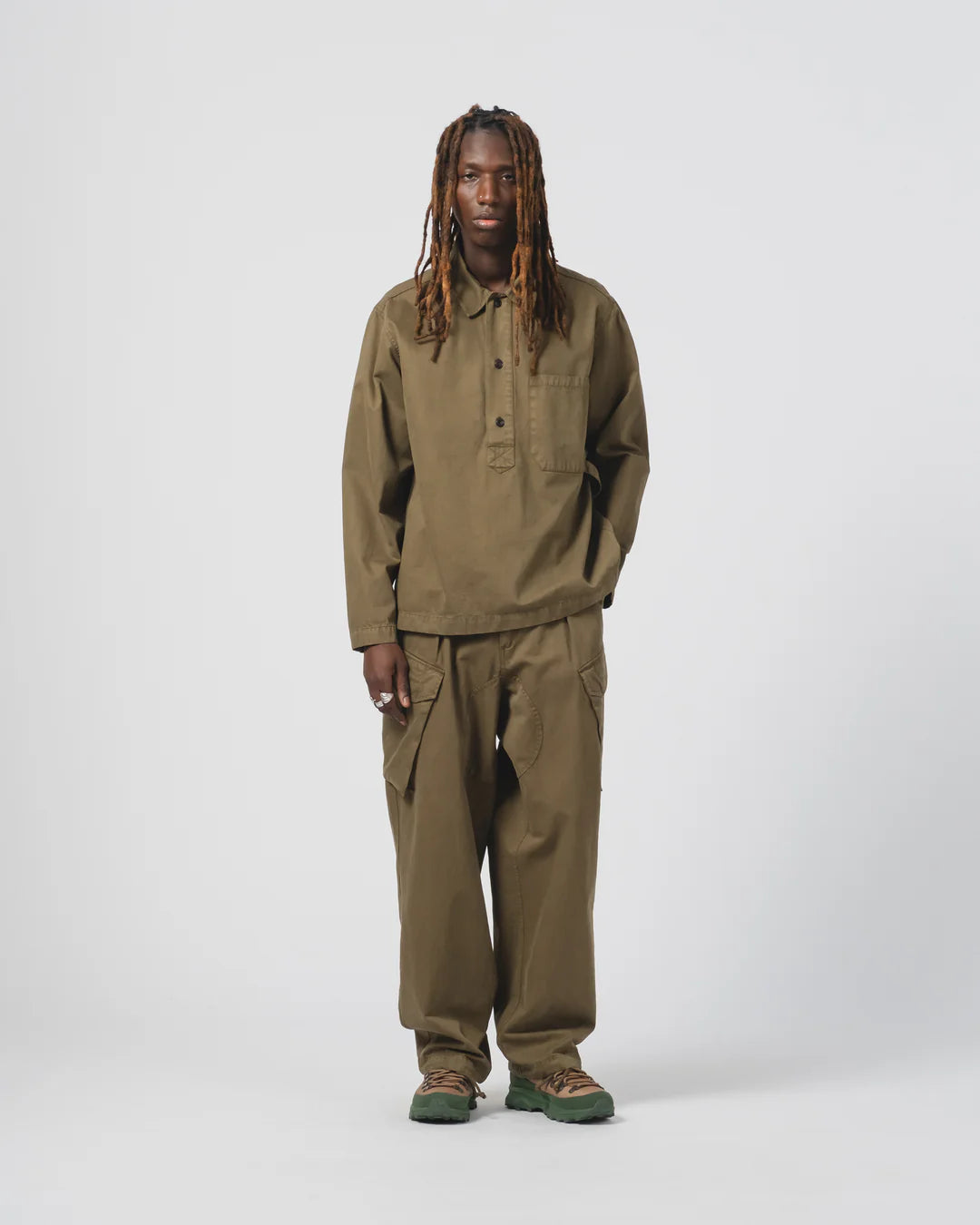 Person wearing an Eat Dust  green outfit on a white background