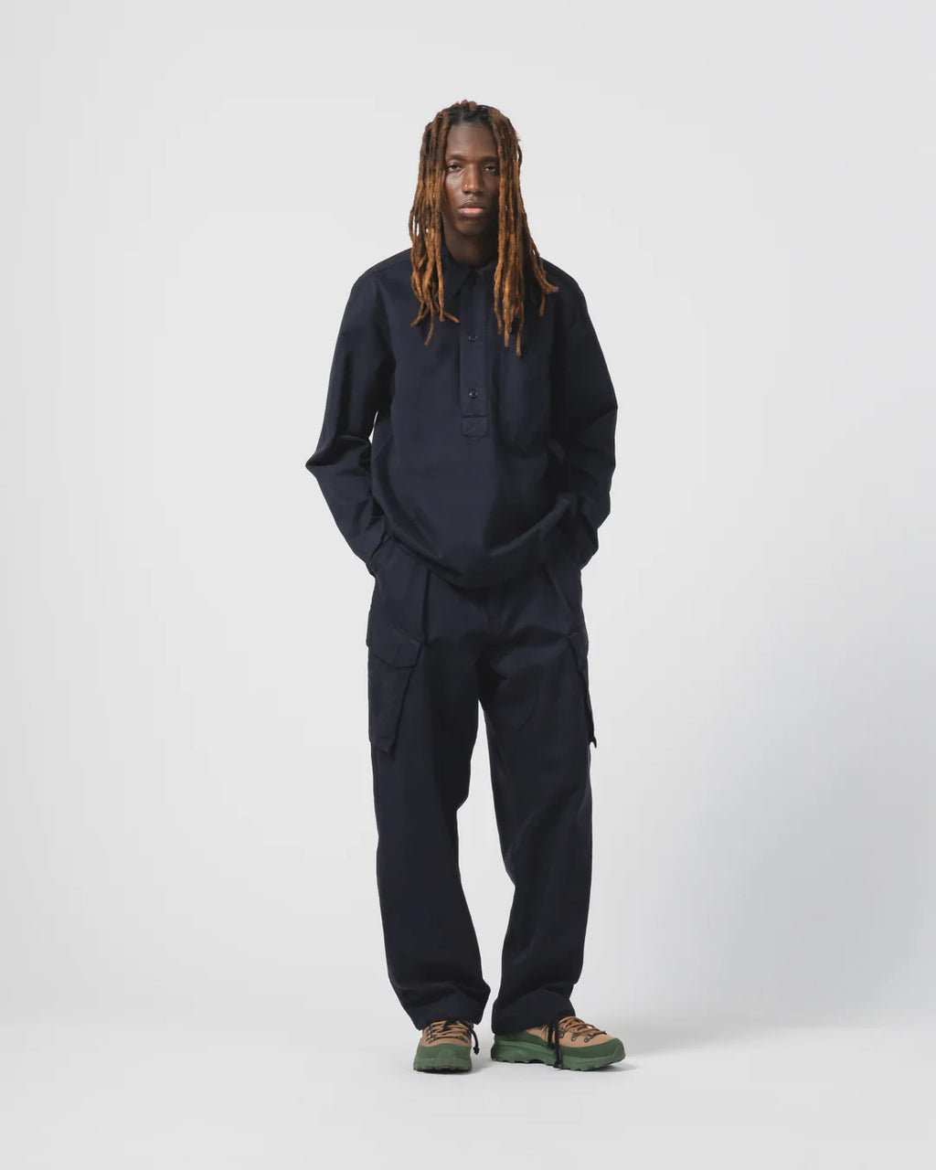 Person wearing a navy Eat Dust  outfit on a white background