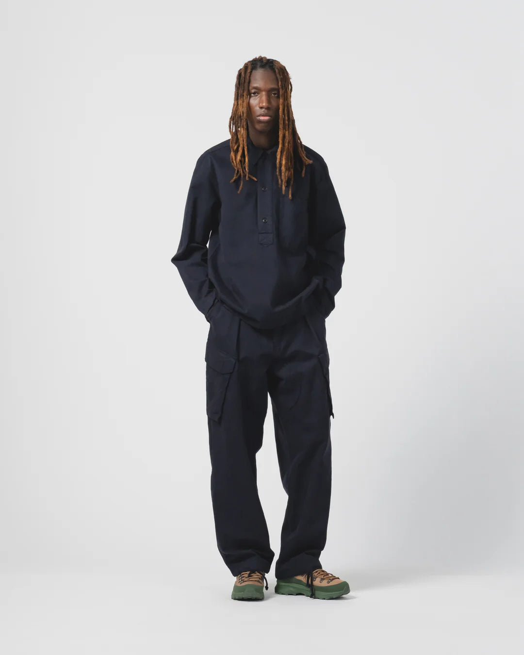 Person wearing a navy Eat Dust  outfit on a white background