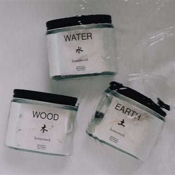 Three candles labeled 'Water', 'Wood', and 'Earth' on a white background.
