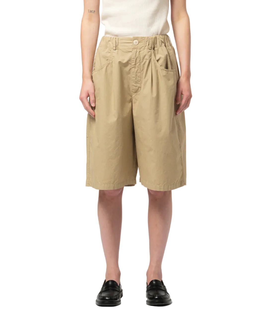 Person wearing beige shorts on a white background