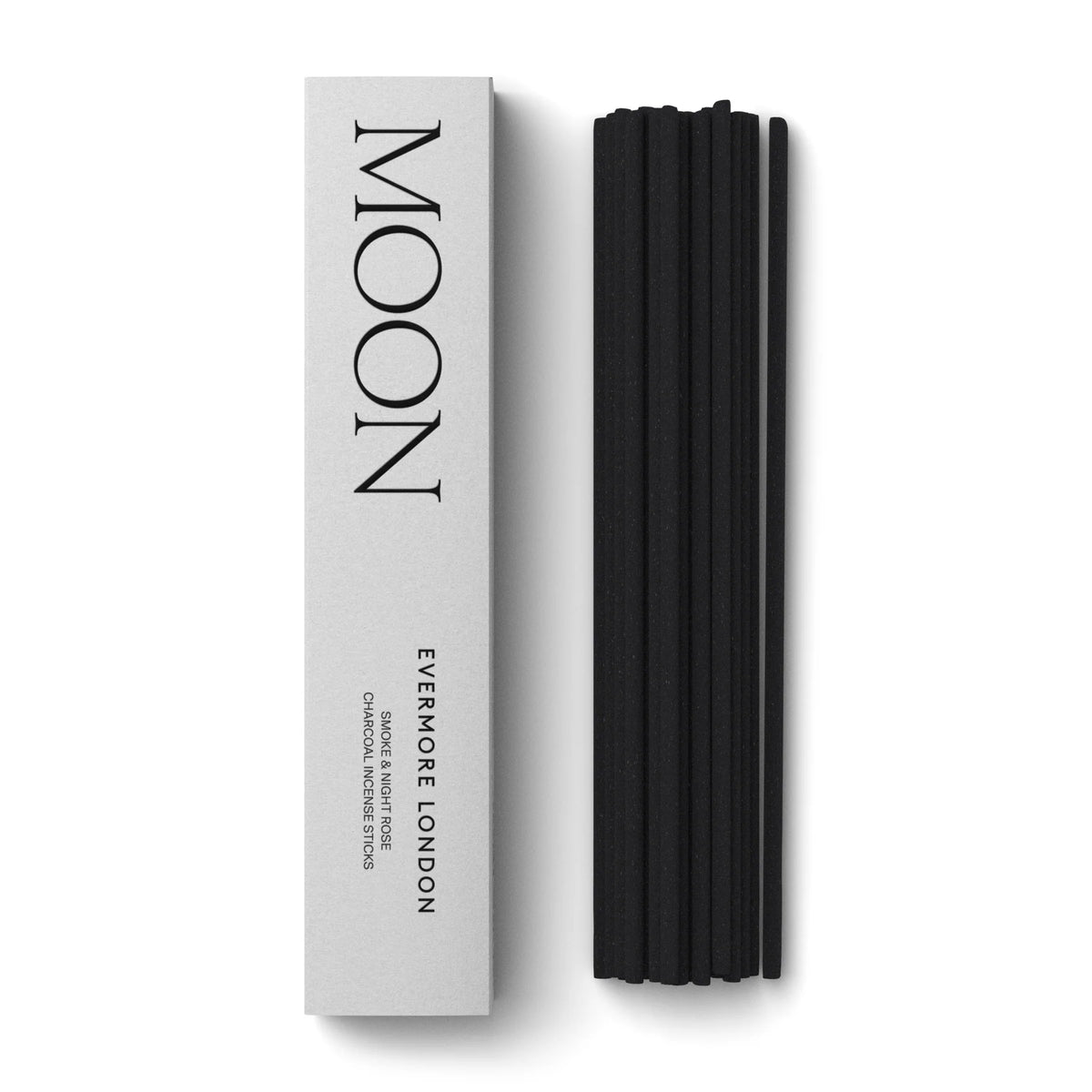 Black incense sticks next to a white box labeled 'MOON' by 'EVERMORE LONDON' on a white background.