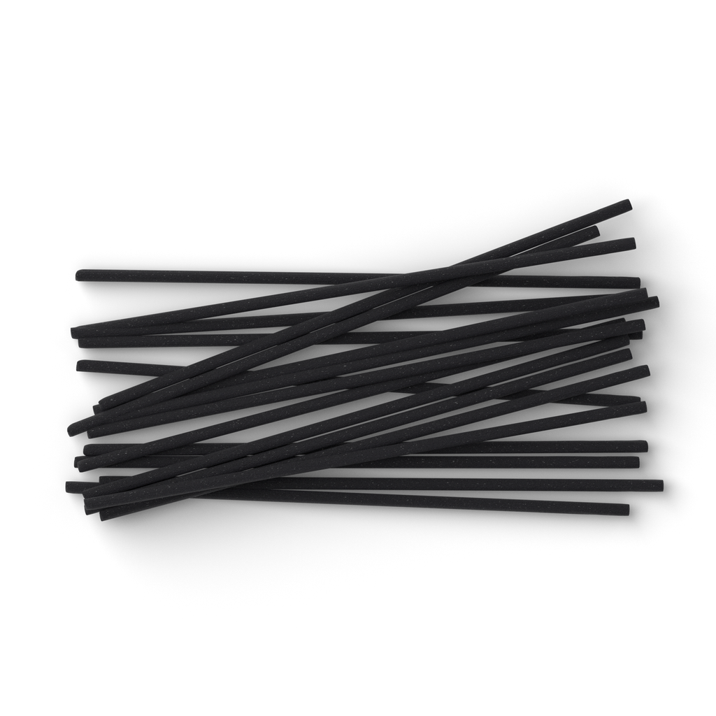 Stack of black incense sticks on a white background