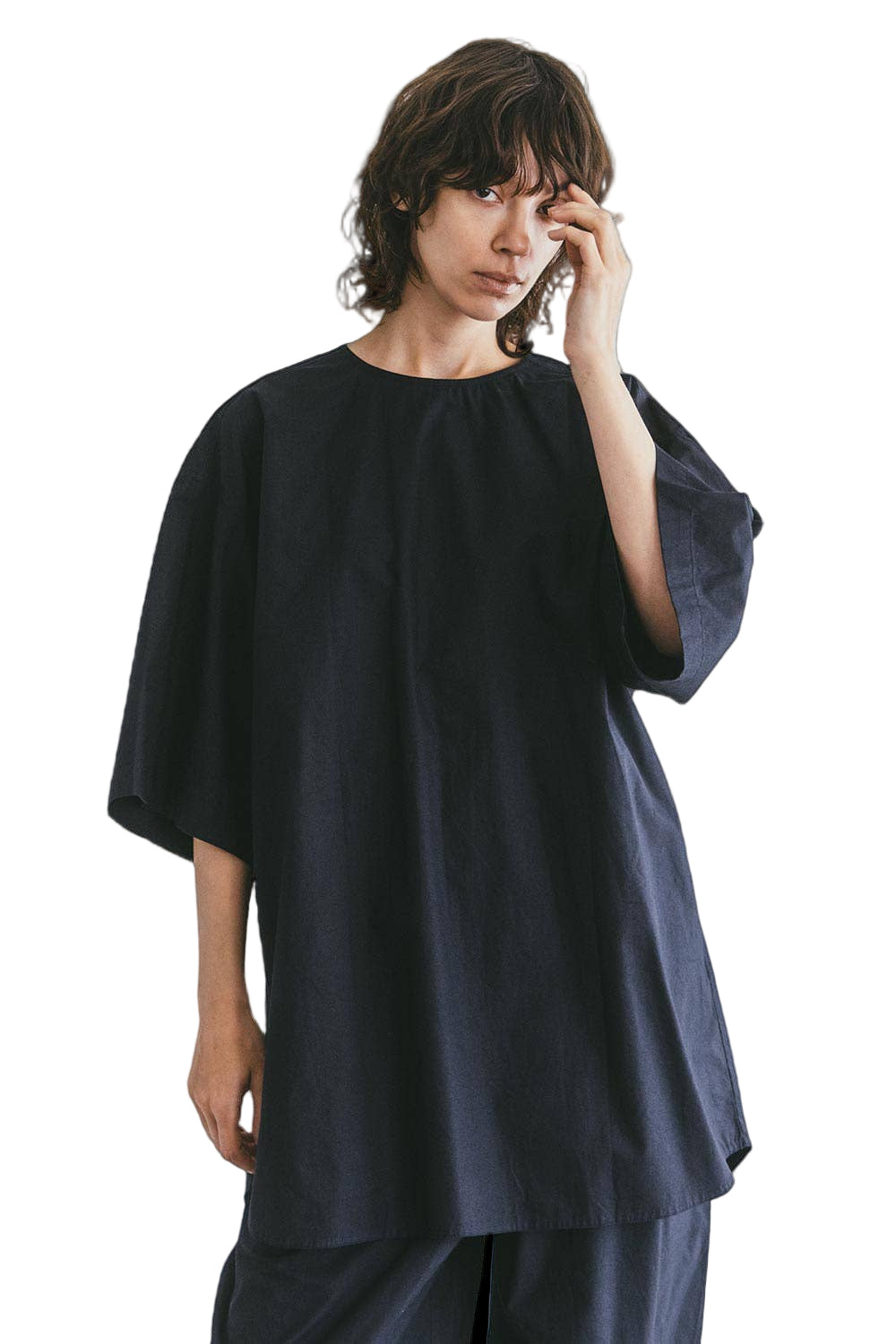 Person wearing a black oversized navy Fog Linen Work, Mii Thaai top against a plain background