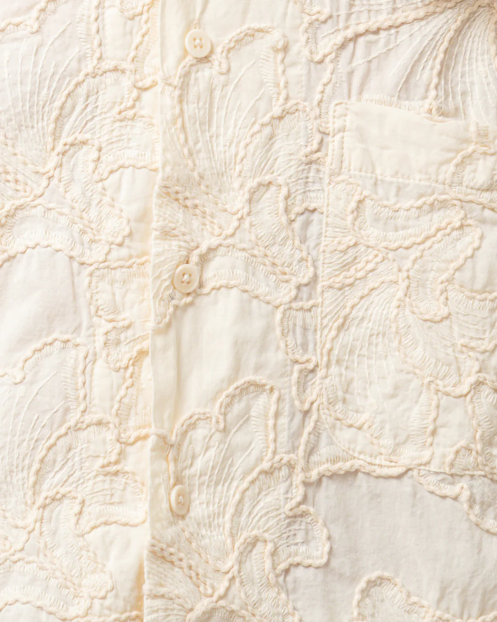 Close-up of textured beige fabric with intricate patterns