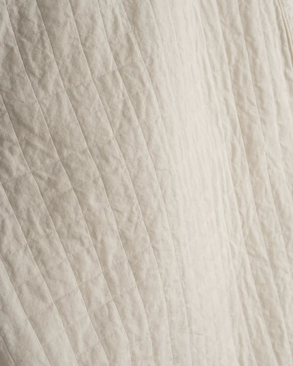 Close-up of textured beige fabric with horizontal lines
