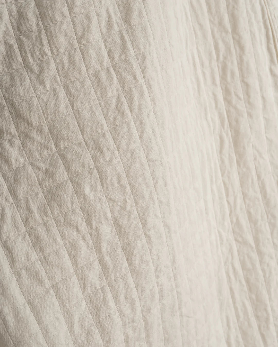Close-up of textured beige fabric with horizontal lines