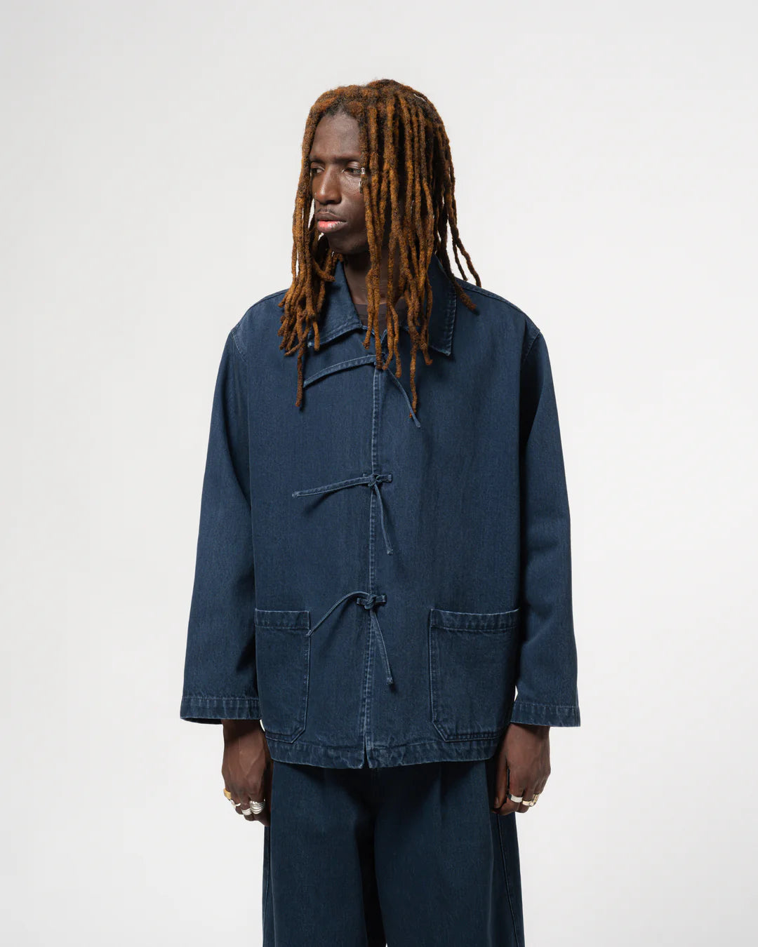 Person wearing a blue jacket on a white background