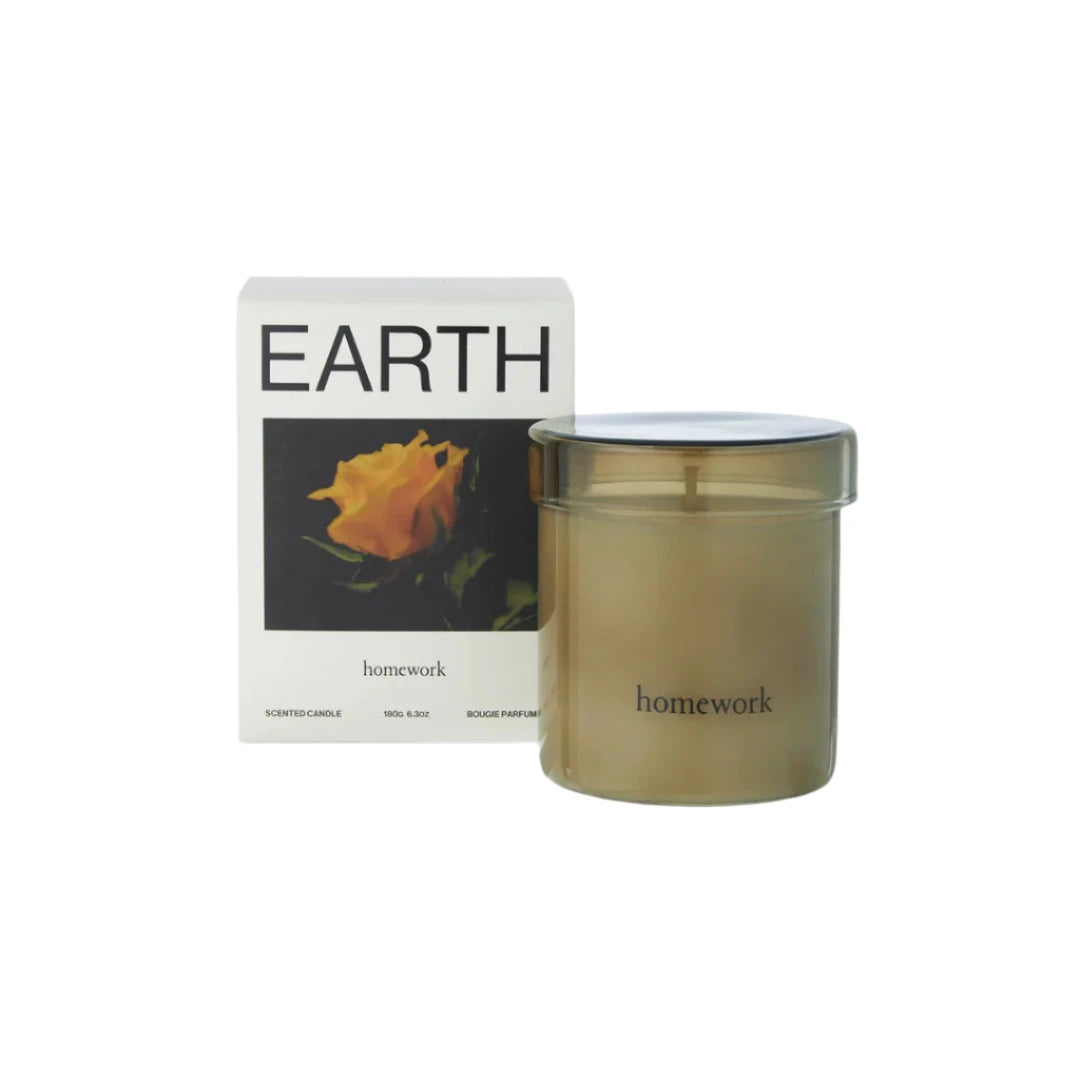 Candle labeled 'homework' with packaging featuring a yellow rose on a white background