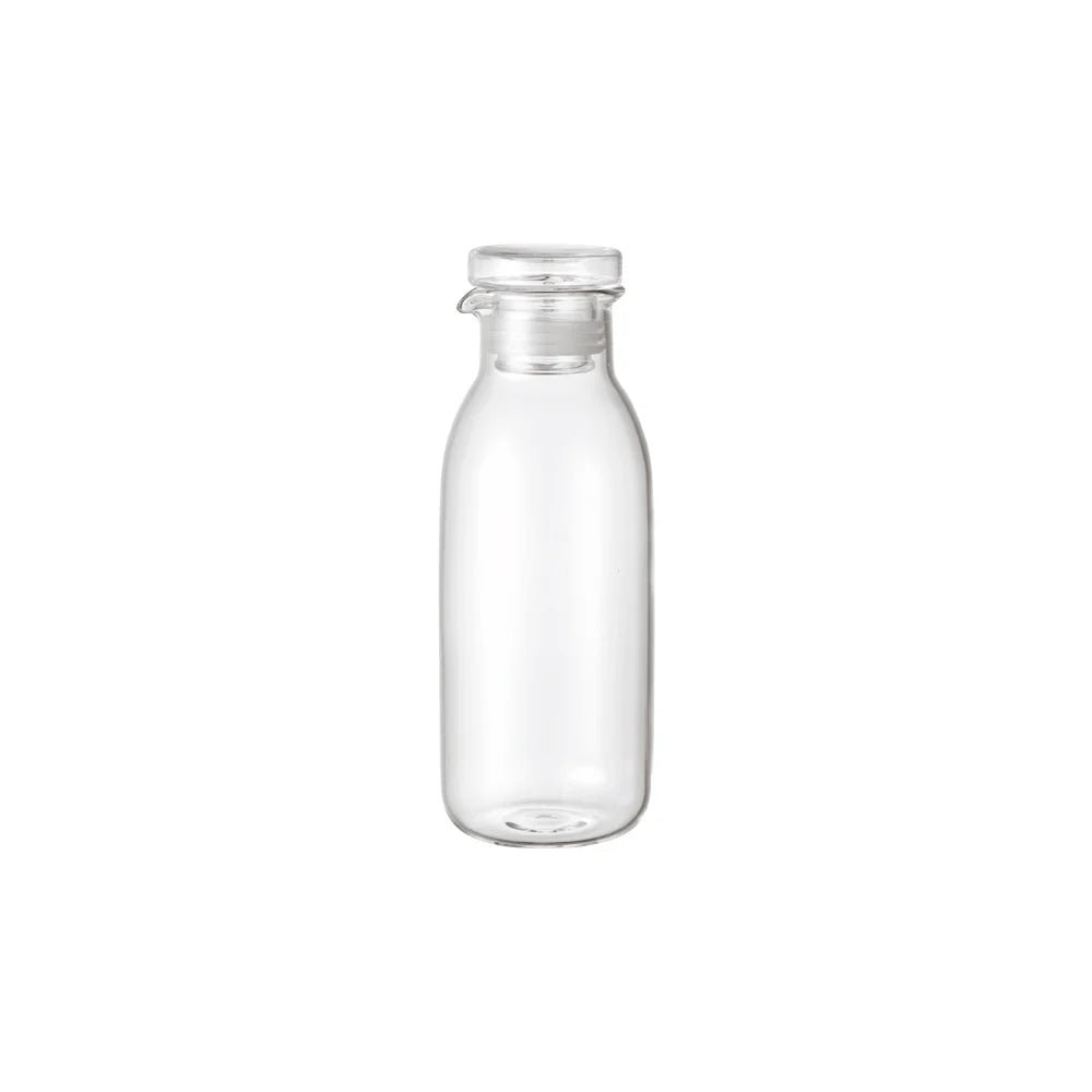 Clear glass dressing bottle on a white background