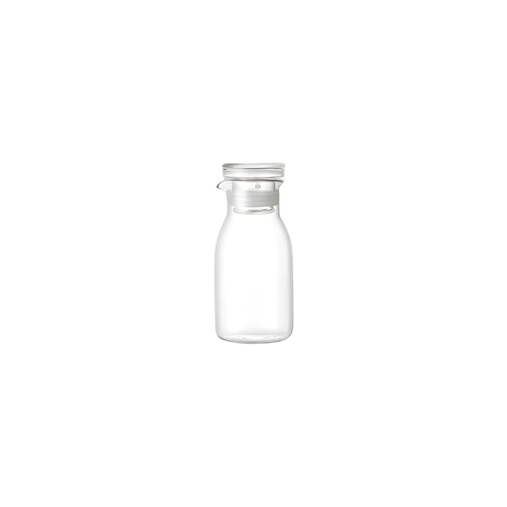 Clear glass bottle with a vacuum lid on a white background