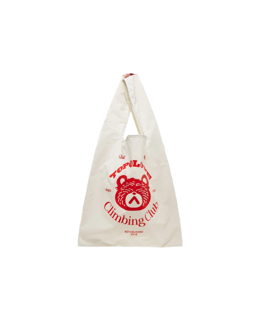 White tote bag with red graphic and text on a gray background