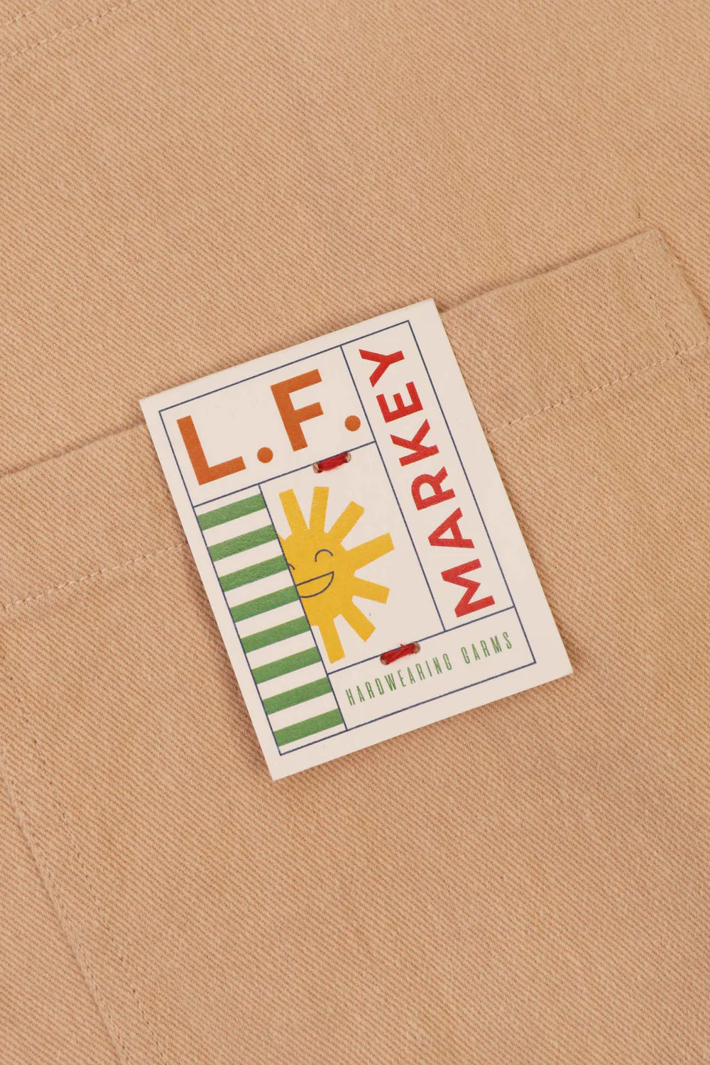 Label with 'L.F. Markey' branding on a beige fabric background