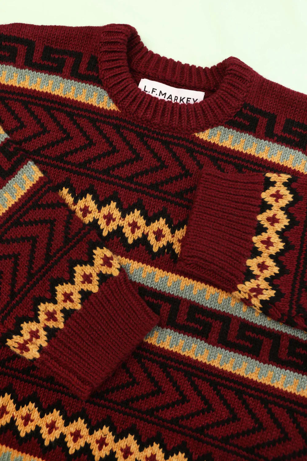 Close-up of a LF Markey patterned sweater with visible brand name on a light background