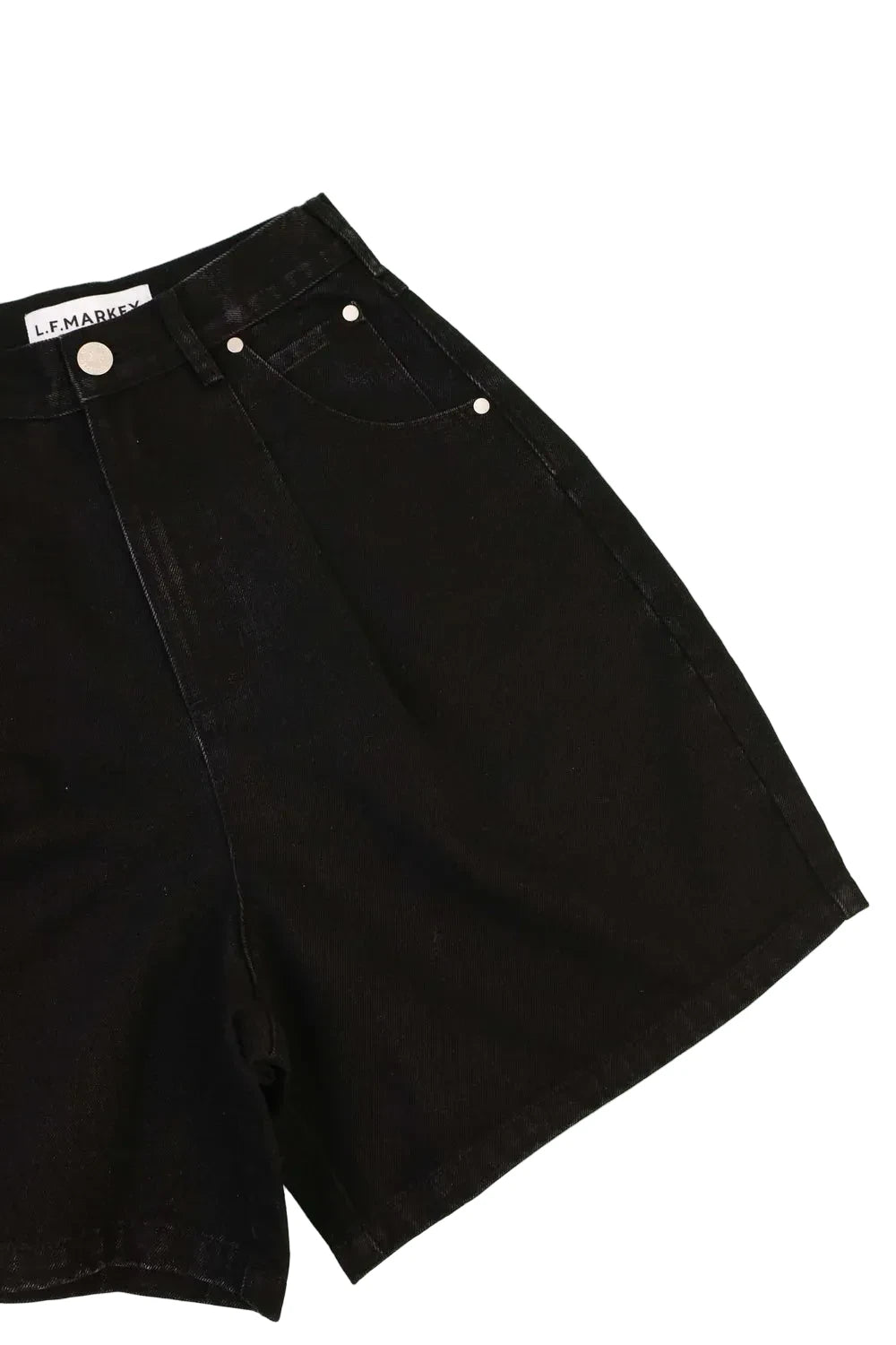 Black denim shorts with button details on a white  background