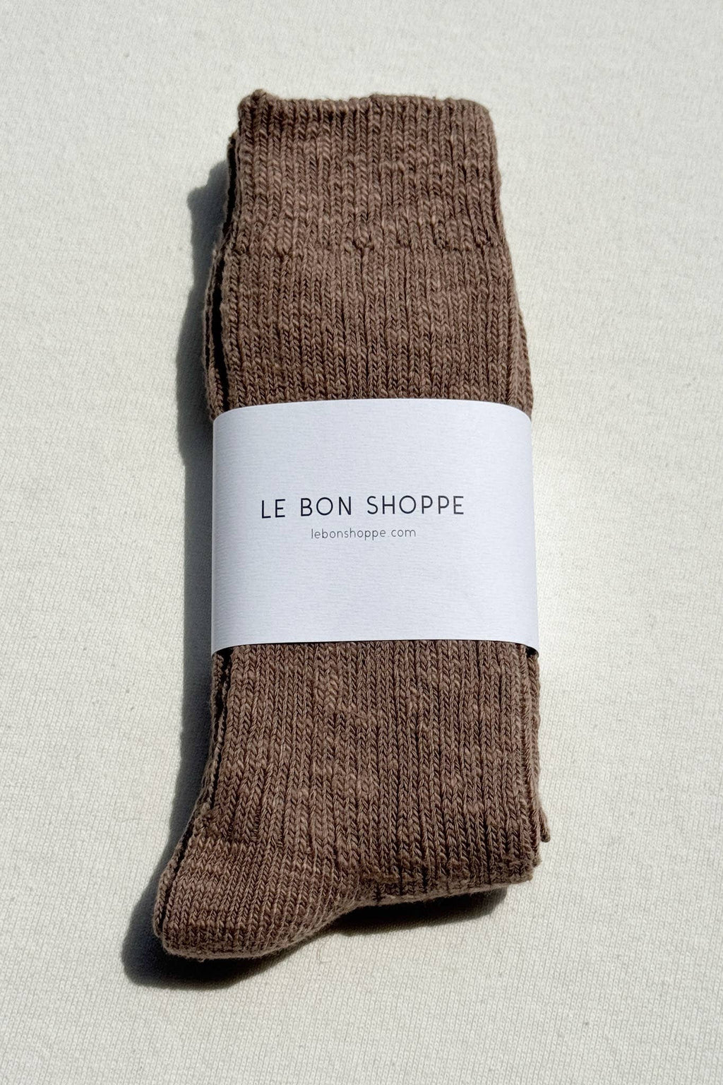 Le Bon Shoppe brown socks with a white label on a light grey background