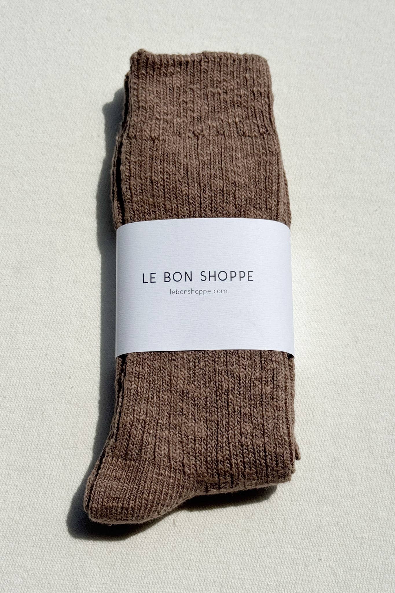 Le Bon Shoppe brown socks with a white label on a light grey background