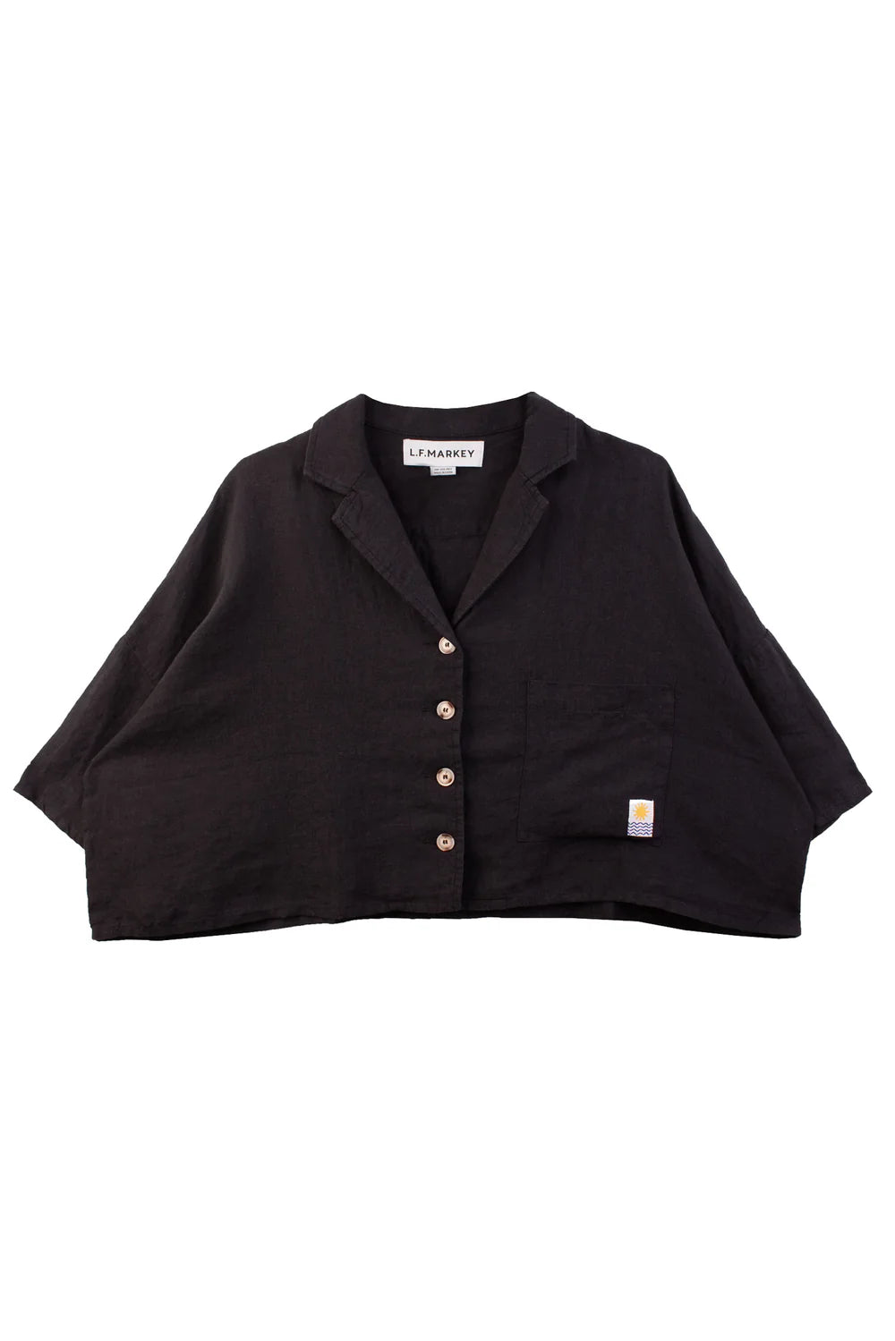 Black cropped blazer with button details on a white background