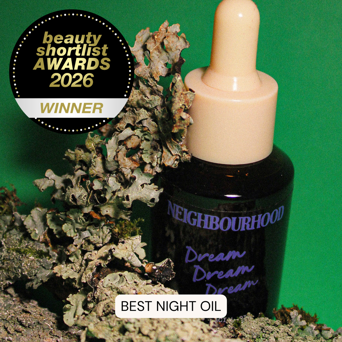 Neighbourhood Dream night oil bottle with lichen on a green background, featuring an award badge.
