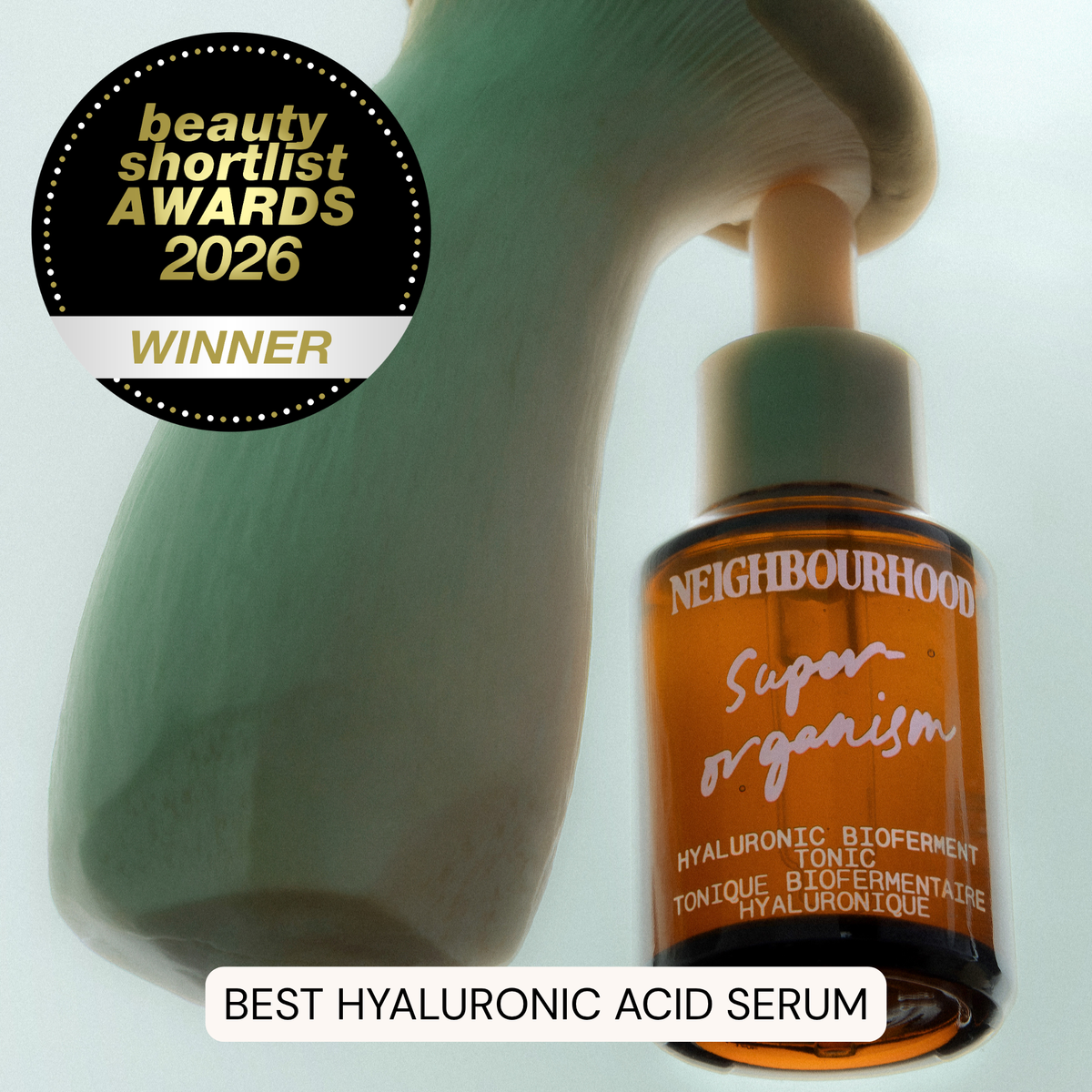 Neighbourhood Super Organism hyaluronic acid serum bottle with an award badge on a light background