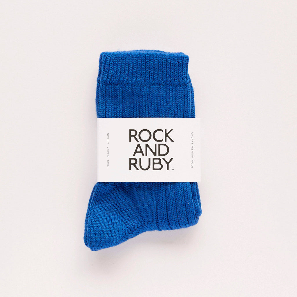 Blue socks with a 'Rock and Ruby' label on a light gray background