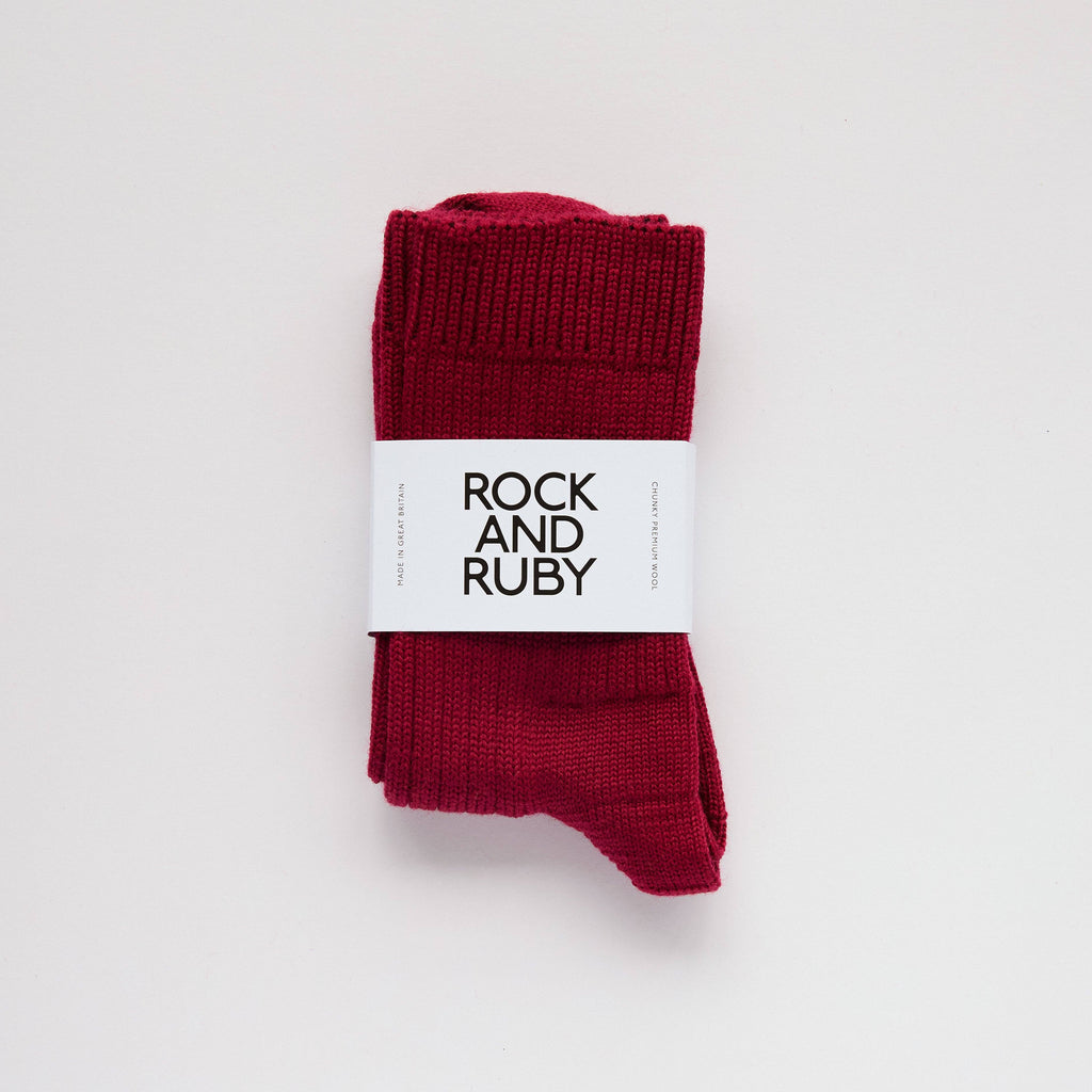 Red socks with a 'Rock and Ruby' label on a light gray background