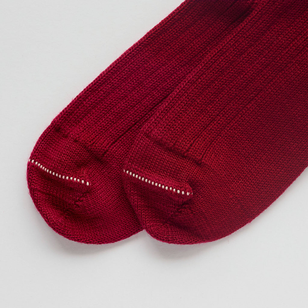 Pair of red socks on a light gray background