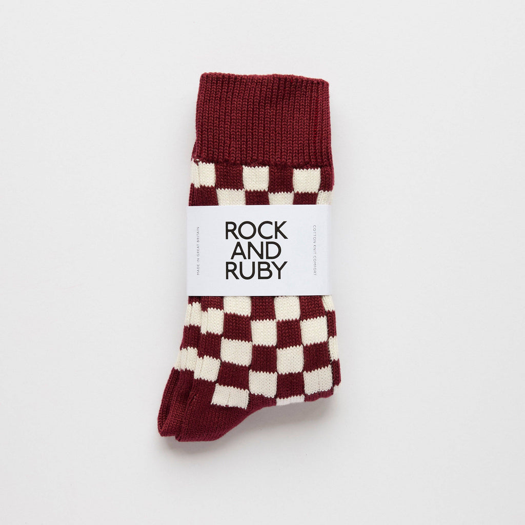 Maroon and white checkered socks with 'Rock and Ruby' label on a light gray background