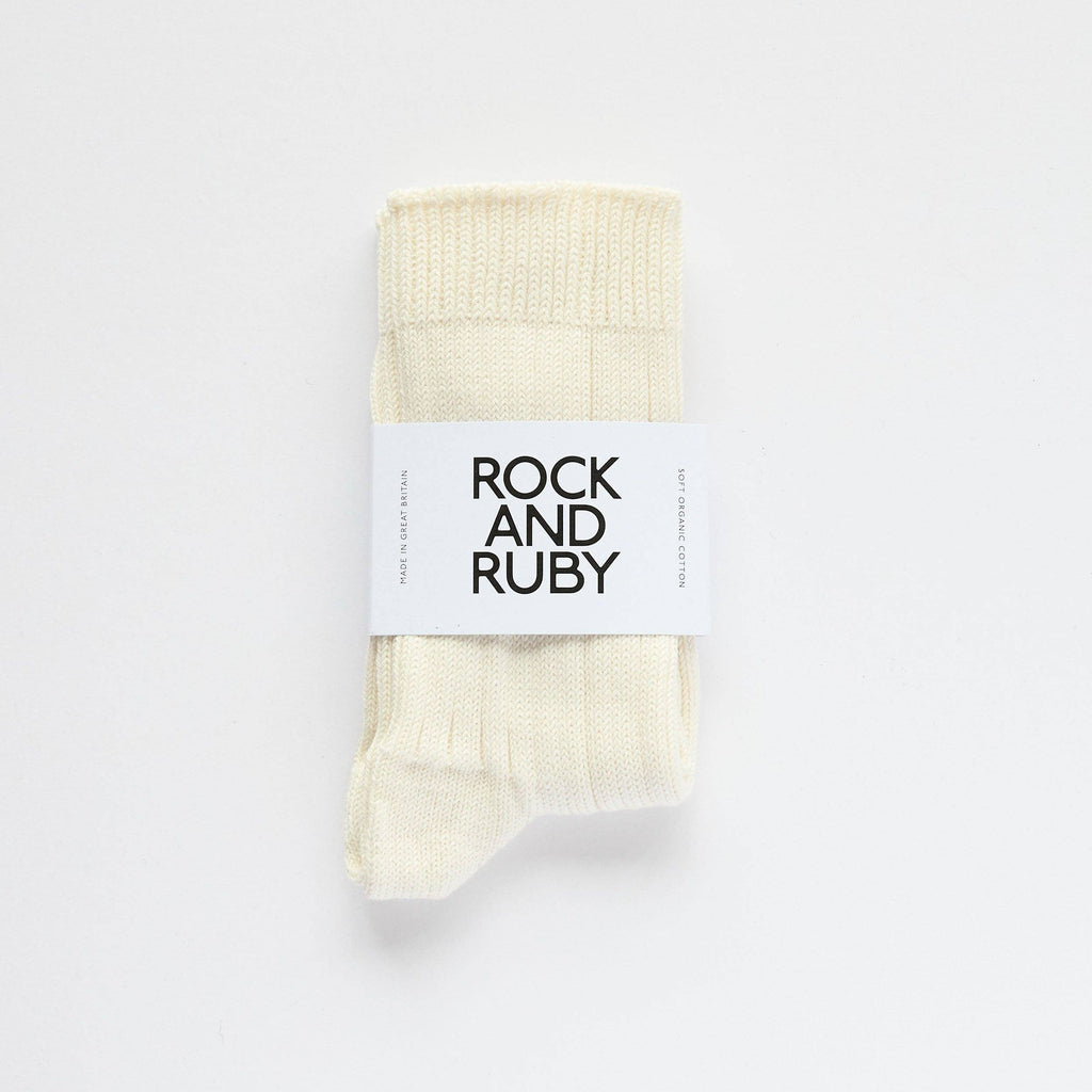 Pack of cream socks with 'Rock and Ruby' label on a white background