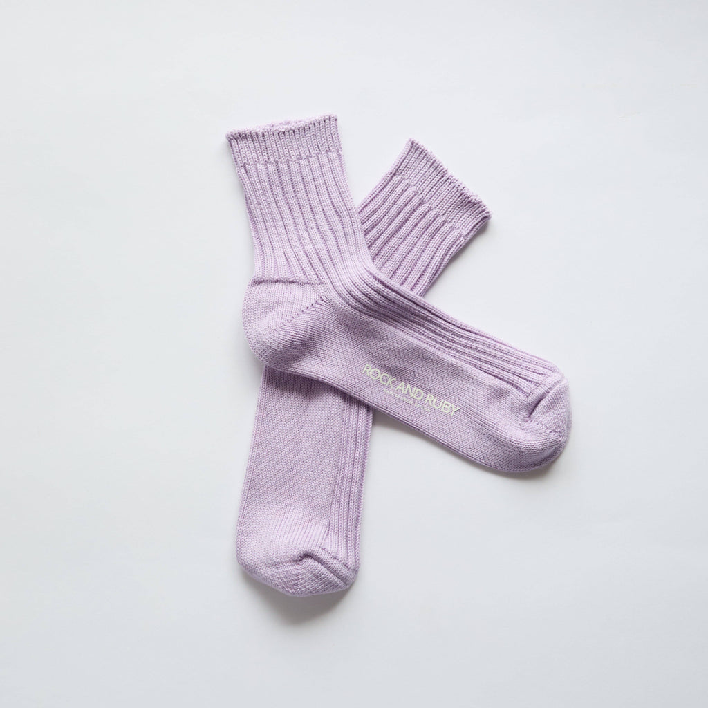 Pair of light purple socks on a white background