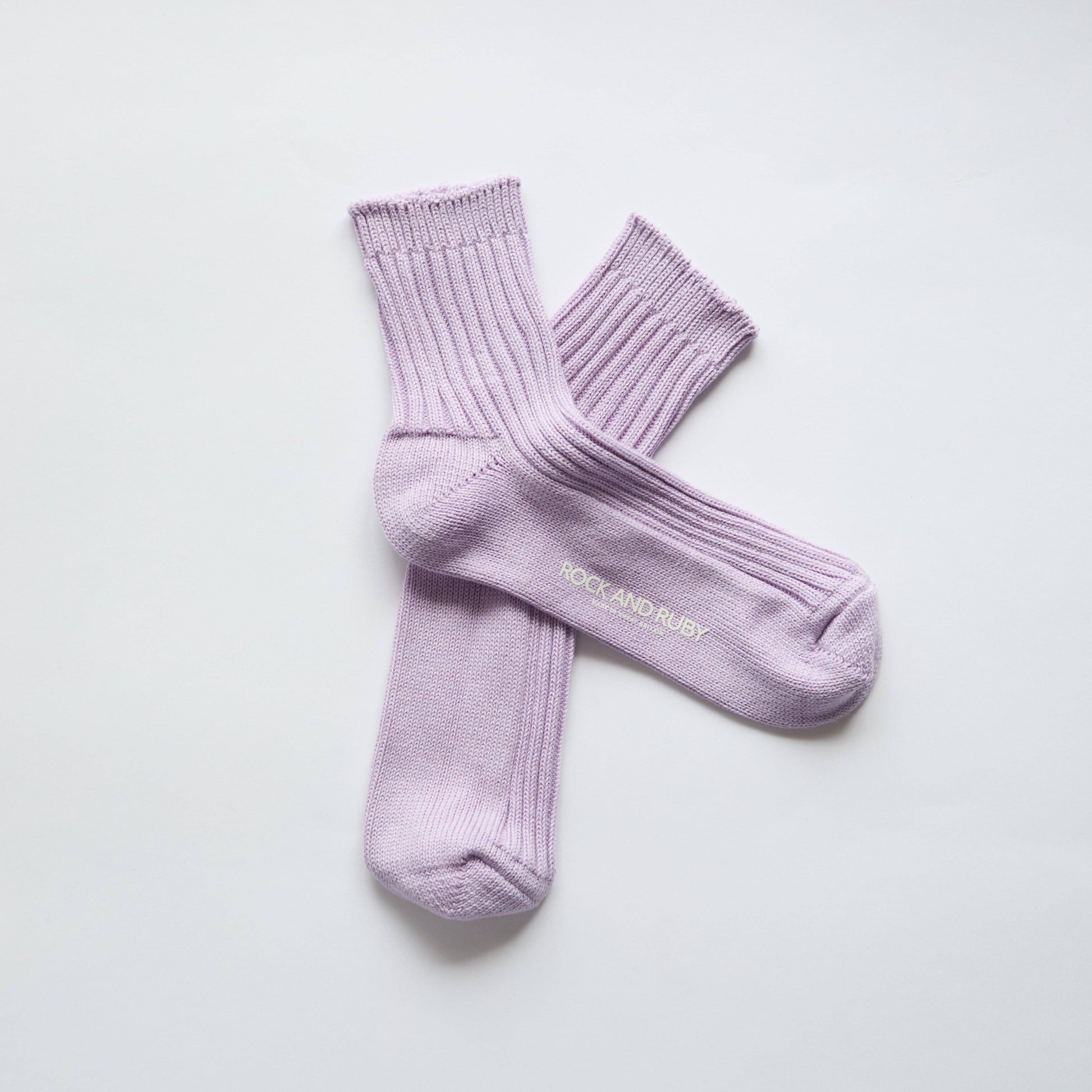 Pair of light purple socks on a white background