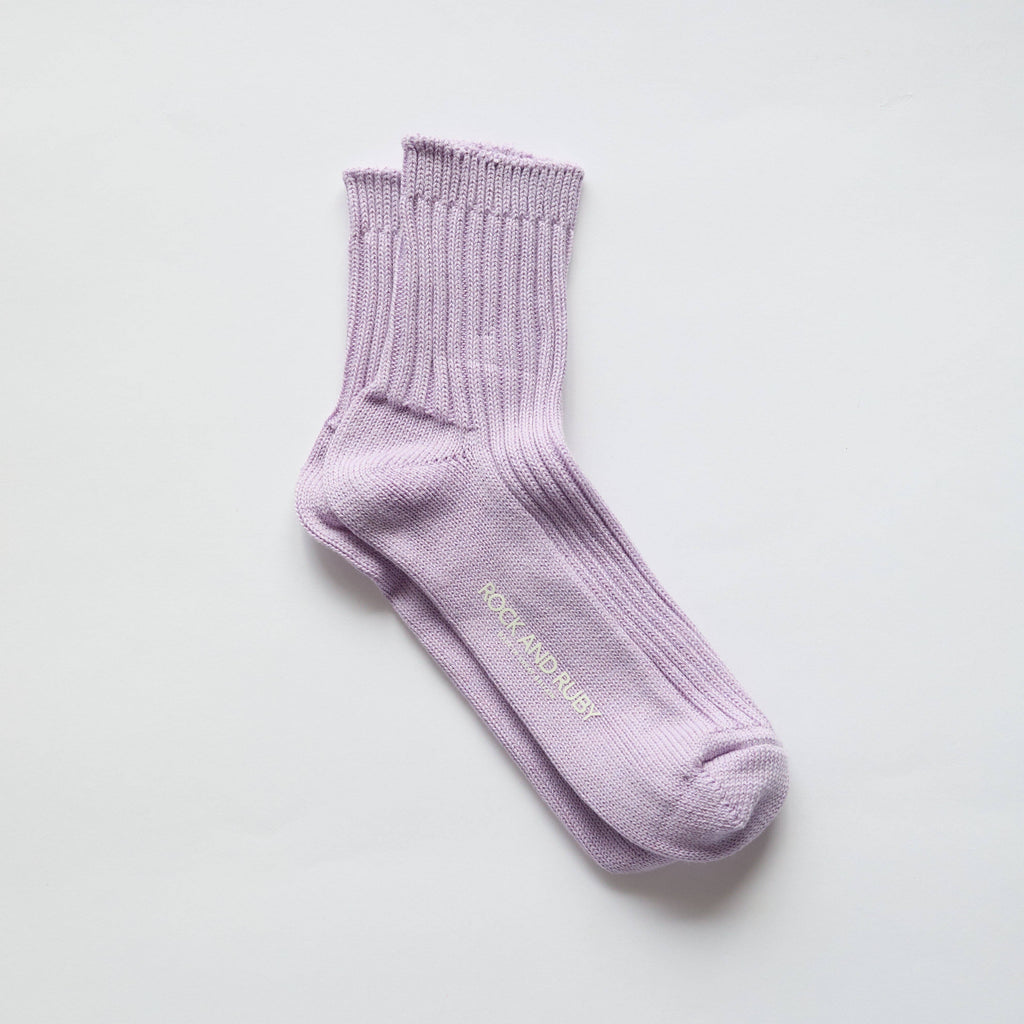 Lavender sock with 'Rock & Raby' branding on a light gray background