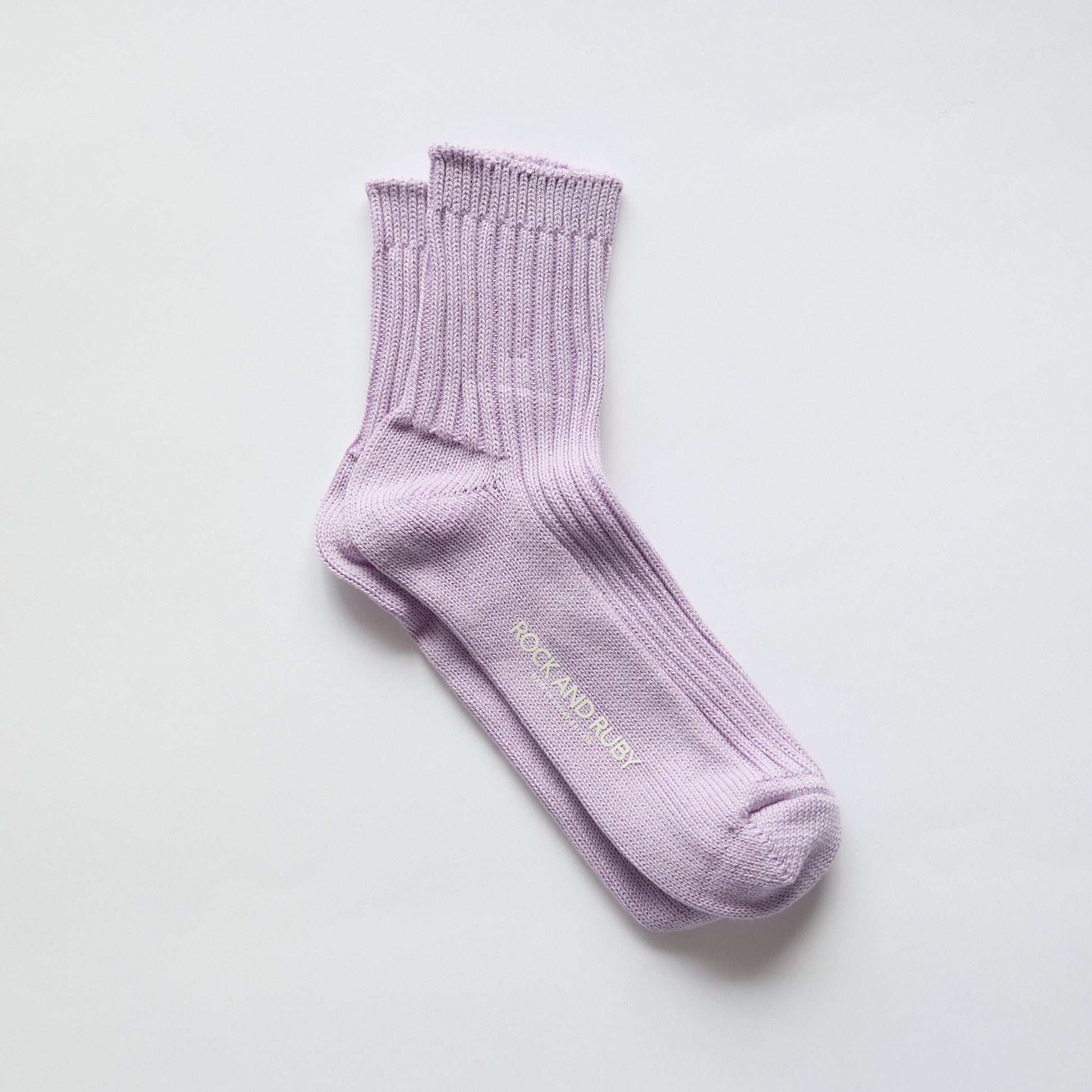 Lavender sock with 'Rock & Raby' branding on a light gray background