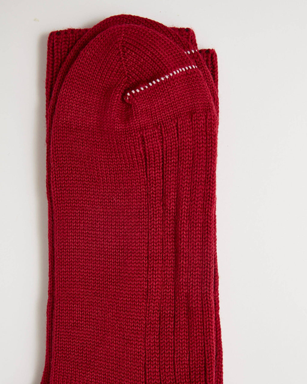 Folded red socks on a white background