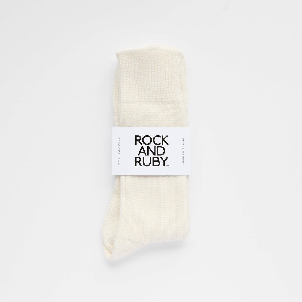 Pair of cream socks with a 'Rock and Ruby' label on a white background